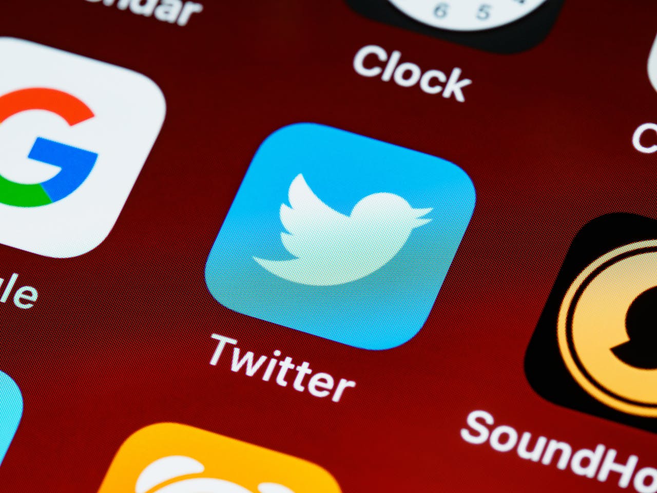 about-us-img Detailed close-up image of popular social media icons on a smartphone screen.